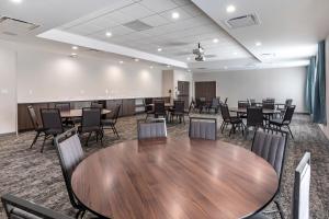 a conference room with a wooden table and chairs at Staybridge Suites Grand Prairie Near Epic Central, an IHG Hotel in Grand Prairie