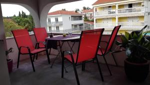 a patio with a table and chairs on a balcony at Apartment Vdovjak in Malinska