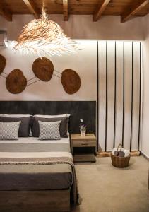 a bedroom with a bed and a chandelier at Vabel Skiathos in Skiathos Town