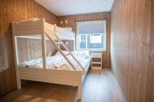a bedroom with a bunk bed and a window at Hodlekve Panorama 5 - amazing view in Sogndal