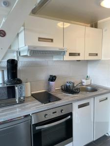 a kitchen with a sink and a stove top oven at Appart port du cap d agde in Cap d'Agde