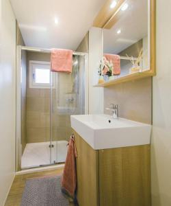 a bathroom with a sink and a shower at Kievit 4 persons in Rijssen