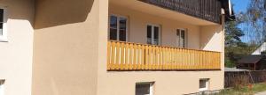 a building with a balcony on the side of it at Am Walde in Trassenheide