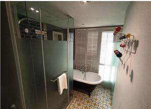 a bathroom with a shower and a tub and a sink at 朵兒dor韓國汗蒸幕 동대문점 商務旅店 in Taipei