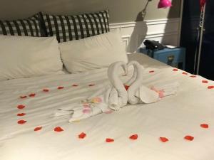 two swans made out of hearts on a bed at 朵兒dor韓國汗蒸幕 동대문점 商務旅店 in Taipei