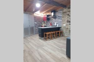a kitchen with wooden floors and a counter top at Apartamento con vistas al río A Solaina in Samos