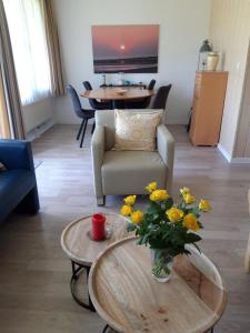 a living room with a vase of flowers on a table at Duinweg 35 in Westkapelle