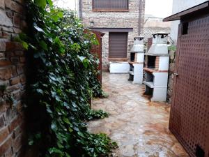 un jardín con lavabos y una pared cubierta de hiedra en Apartamento Abuela Benita, en Cebreros