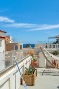 a view of the ocean from the balcony of a house at Castel Abaso Boutique Apartments in Andros