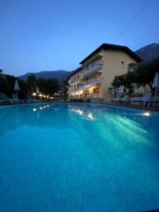 a large swimming pool in front of a building at Hotel Casa Serena in Malcesine