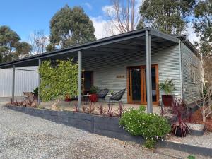 a small house with a black roof at Omaroo High Country Retreat in Bonnie Doon
