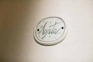 a clock on a wall with the word india on it at B&B Le Gemme in Dolceacqua