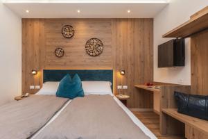 une chambre avec un grand lit et des murs en bois dans l'établissement Hotel Pejo, à Peio Fonti 71 autres photos