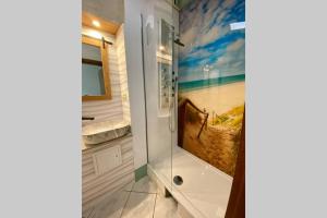 a bathroom with a shower with a painting on the wall at Roggendorf in Mechernich