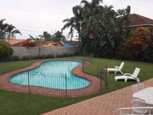 a fence around a swimming pool in a yard at 8 Oyster in Durban