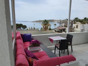 a couch on a balcony with a view of the water at R HOUSE HOTEL in Bodrum City