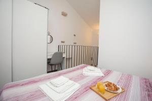 a room with a bed with a tray of food on it at Studio apartman Amalie in Pazin
