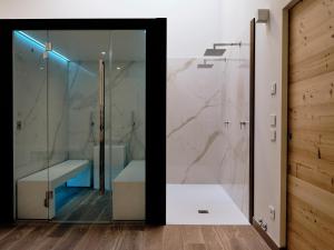 a bathroom with a shower and a glass door at Hotel Ristorante Magia del Brenta in Fiesso dʼArtico