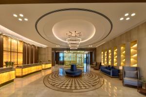 a lobby of a hotel with a chandelier at Grand Swiss-Belhotel Waterfront Seef in Manama