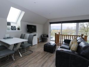 a living room with a couch and a table at The Loft in Spean Bridge