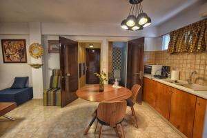 a kitchen with a wooden table and a dining room at Studio Sun in Arta