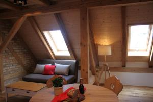 a living room with a couch and a table at Ferienwohnungen Zwergbachhof in Haunsheim +33 photos