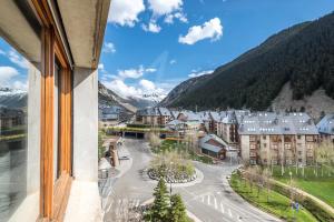 a view from a window of a town with mountains at Solneu by SeaMount Rentals in Naut Aran