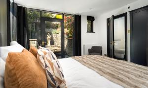 a bedroom with a bed and a large window at Sweden Lodge - wonderful property in Ambleside in Ambleside