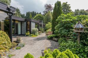 a garden with a patio and a house at Sweden Lodge - wonderful property in Ambleside in Ambleside