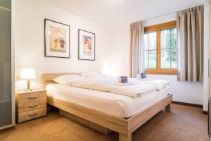 Postel nebo postele na pokoji v ubytování Apartment Jungfrau - GRIWA RENT AG
