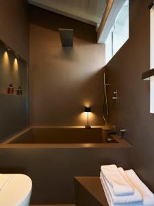 a bathroom with a tub and a toilet and a sink at OBERDAN SUITE Appartamento nel cuore di Bologna in Bologna