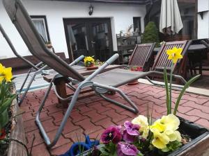 a pair of chairs sitting on a patio with flowers at Ubytovanie v Banskej Štiavnici u Antalov in Banská Štiavnica