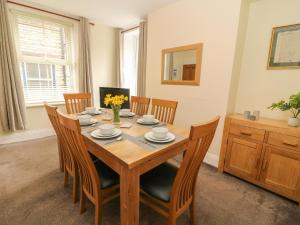 a dining room with a wooden table and chairs at Rockville in Hawes