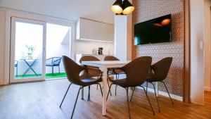 a dining room with a table and chairs at Porto Vecchio Appartamenti in Lazise