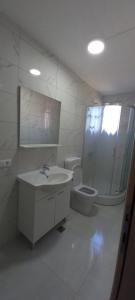 a white bathroom with a toilet and a sink at Spirit in Međugorje +9 photos