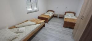 a room with three beds and a window at Spirit in Međugorje