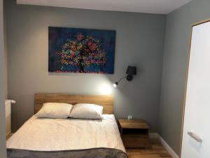 Posteľ alebo postele v izbe v ubytovaní Leonia- Apartamenty i Pokoje Gościnne