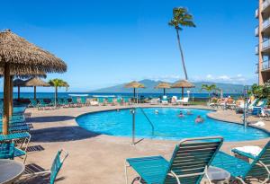 a pool at a resort with chairs and people in it at Royal Kahana 309 1 Bedroom Condo condo in Kahana