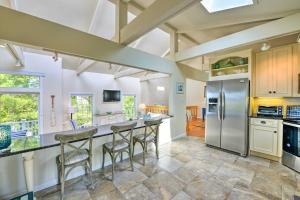 a kitchen with a large island with bar stools at Coastal Cape May Getaway - Steps to Beach! in Cape May