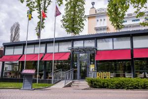 a large building with a red awning at RICH Boutique-Hotel in Vinnytsya