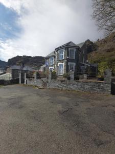 Casa grande con una pared de ladrillo. en isallt guesthouse en Blaenau-Ffestiniog