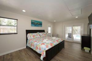 a bedroom with a bed and a tv in it at Heated Pool Home - Close to Beaches, Restaurants & More! in Sarasota +22 photos