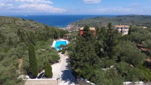 an aerial view of a resort with a swimming pool and the ocean at Bella Vista Villas & Suites in Gaios