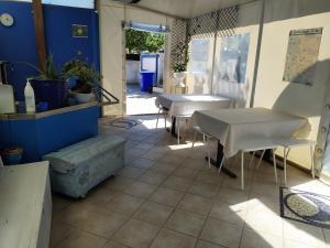 a room with two tables and chairs and a patio at B&B Luna Blu in Carbonia