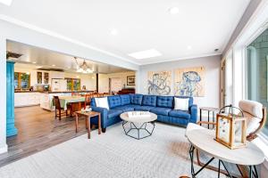 a living room with a blue couch and a kitchen at Ocean Trails in Mendocino