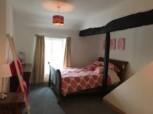 a bedroom with a bunk bed and a window at Old Hall cottage in Hope