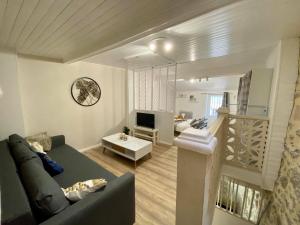 a living room with a couch and a living room with a stair at Le Cosy City - Agde Centre in Agde