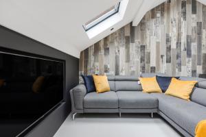 a living room with a couch and a tv at Winter Garden Apartments by Sasco in Blackpool