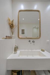 a bathroom with a white sink and a mirror at Jardin De Castillo , Naxos Town in Naxos Chora +99 photos