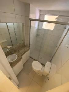 a bathroom with a toilet and a sink at Brisa do Mar Apartments in Fortaleza